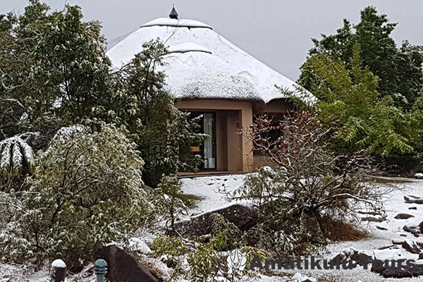 Thendele chalets nestled below the Amphitheatre cliffs in Royal Natal National Park, Northern Drakensberg