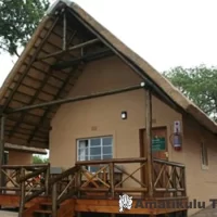 Two-sleeper self-catering chalet at Mpila Camp featuring a private deck and bushveld views in Hluhluwe-iMfolozi Game Reserve, South Africa
