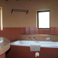 Bathtub at Didima Camp – comfortable bathroom feature in chalet accommodation in the Drakensberg, KwaZulu-Natal, South Africa