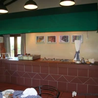 Giant’s Castle restaurant with wooden tables, warm lighting, and a view of the Drakensberg mountains