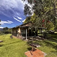 Front view of a 4-bed self-catering chalet at Injisuthi Camp with mountain backdrop in the uKhahlamba-Drakensberg Park, South Africa