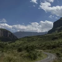 Dirt road leading to Injisuthi Camp, surrounded by natural mountain scenery in uKhahlamba-Drakensberg Park, South Africa