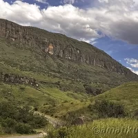 Scenic mountain landscape surrounding Injisuthi Camp in uKhahlamba-Drakensberg Park, featuring dramatic peaks and lush valleys in South Africa