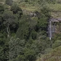 Waterfall near Injisuthi Camp cascading down rocky cliffs in the heart of uKhahlamba-Drakensberg Park, South Africa