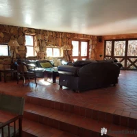 Comfortable lounge area at Ntshondwe Camp in Ithala Game Reserve with views of surrounding cliffs and bushveld, South Africa