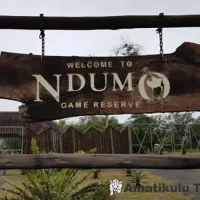 Main entrance to Ndumo Game Reserve featuring signage and access gate surrounded by natural bushveld in KwaZulu-Natal, South Africa