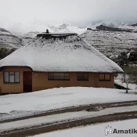 Snow-covered landscape at Thendele Camp in Royal Natal National Park with views of the Drakensberg Amphitheatre
